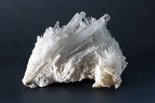 Isolated Scolecite mineral made of sprays of thin, prissmatic needles crystals. Scolecite is a tectosilicate mineral belonging to the zeolite group. From Poona, India.