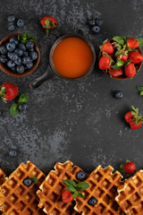 Traditional belgian waffles with fresh berries and sweet topping