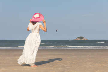 Fototapeta na wymiar Woman in white dress on beach