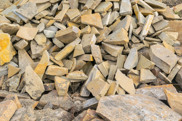 Background, pile, of pieces of roughly broken raw marble stones