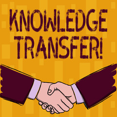 Writing note showing Knowledge Transfer. Business concept for sharing or disseminating of knowledge and experience Businessmen Shaking Hands Form of Greeting and Agreement