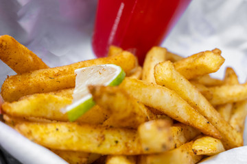 Spicy french fries and cola in red cup, fast food