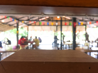 empty wooden table with blurred restaurant background.