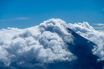 Inactive volcano in Guatemala against the blue sky in the clouds. photo in blue colors