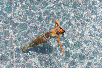 woman in luxury spa resort near the swimming pool.