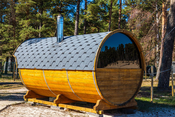 a cask-shaped farmhouse in front of the forest