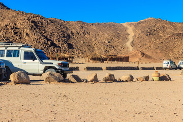 Off road SUV cars in bedouin village in Arabian desert near Hurghada, Egypt