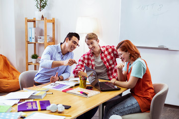 Delighted nice young students having fun together