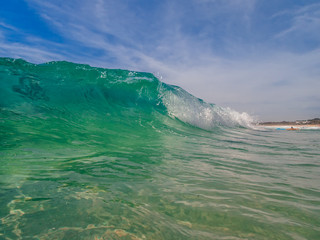Ocean beach wave curling  onto the shore