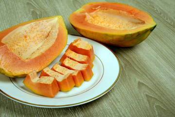 Slices of fresh and ripe seedless papaya in dish