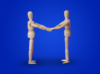 Wooden toy figures handshake on blue
