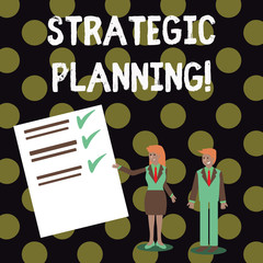 Text sign showing Strategic Planning. Business photo showcasing systematic process of envisioning a desired future Man and Woman in Business Suit Presenting Report of Check and Lines on Paper