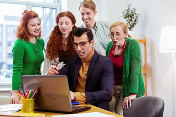 Handsome smart young man speaking about business