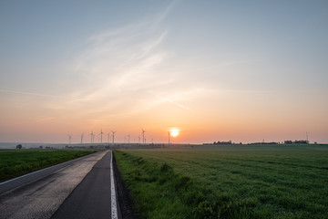 sunrise at a windpark in germany