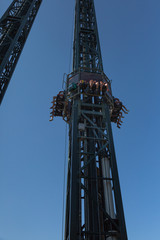 Fototapeta na wymiar Metallic Tower in the Amusement Park: Crazy Speed Uphill and Downhill