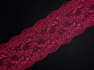Red laces on a black background diagonally