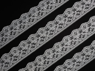 White laces on a black background diagonally