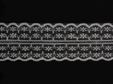 White laces on a black background horizontally in one row