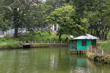 Fototapeta na wymiar small house standing on a lake shore