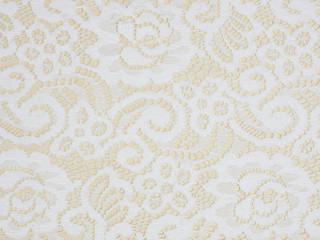White laces on a beige background macro