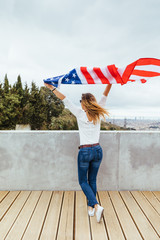 Happy woman holding an American Flag