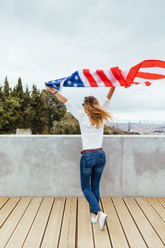 Happy Woman Holding An American Flag