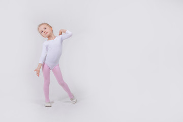 Happy little girl dancing isolated on white background