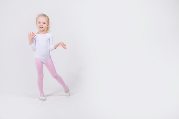 Happy little girl dancing isolated on white background