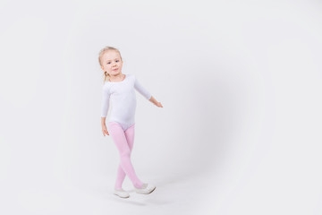 Happy little girl dancing isolated on white background