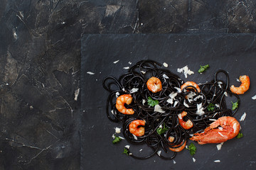 Squid ink pasta with prawns and tomatoes