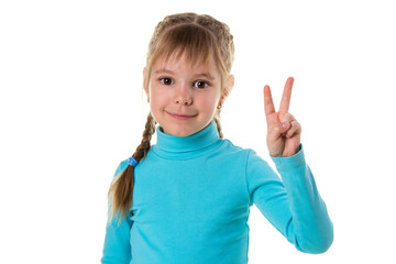 Indoor portrait of European girl isolated on white background with optimistic smile, showing victory sign looking friendly and willing to welcome and communicate