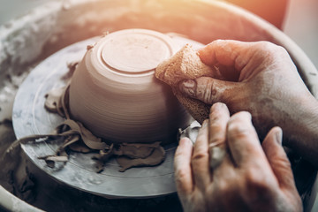 Master of old wrinkle hands works on potter wheel. Concept perseverance and patience.