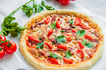 Pizza with mozzarella and tomatoes on the table