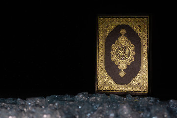 Quran in the mosque on the table, black background