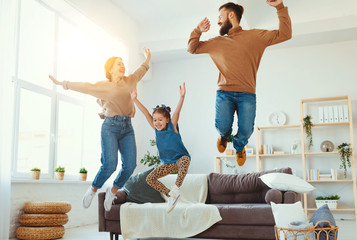 happy family mother father and child daughter dancing at home