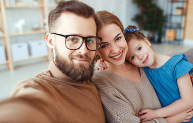 Fototapeta premium cheerful happy family mother father and child take selfies, take pictures.