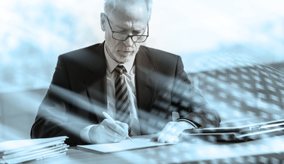 Businessman signing a document, black and white; multiple exposure