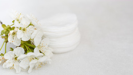 hygienic disposable product cosmetic pads and flower on white towel background with copy space . skin body care concept