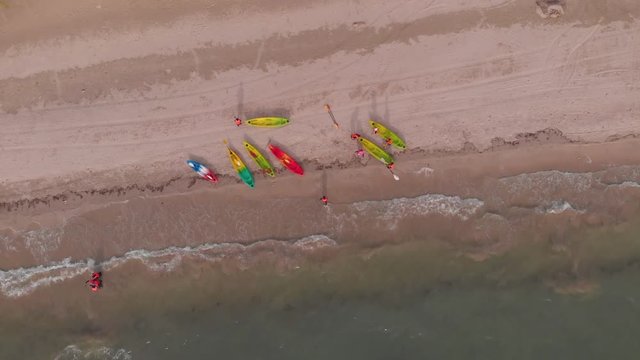 Aerial Top View of a Sandy Beach With Turquoise Water and visitor in kayaking around beach at Labuan, Malaysia