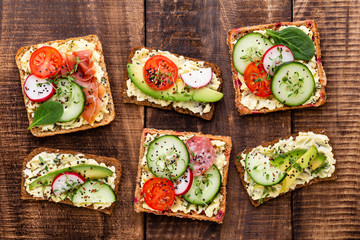 Sandwiches with cream cheese, vegetables and salami.