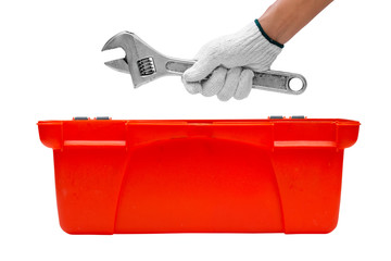 Worker hand holding spanner with toolbox isolated on white background - clipping paths.