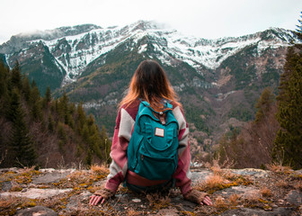 Young girl from behind looking at the mountains.