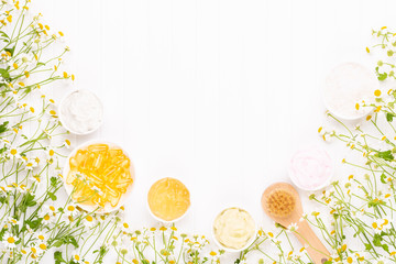 Spa still life with aromatherapy chamomile, herbal oil, soap, sea salt.