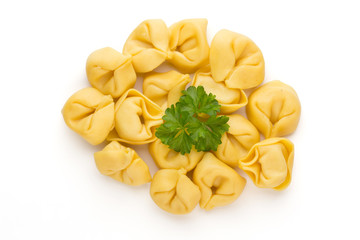 Raw homemade pasta,tortellini with herbs.