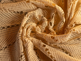 Beautiful handmade knitted lace tablecloth in soft sunlight
