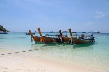 Fototapeta na wymiar Long-tail wooden boats anchored on tropical sea in andaman
