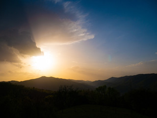 Beautiful landscape in the mountains at sunset. View of colorful sky with amazing clouds.