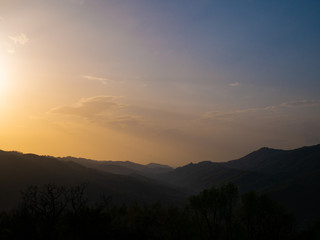 Beautiful landscape in the mountains at sunset. View of colorful sky with amazing clouds.