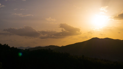 Beautiful landscape in the mountains at sunset. View of colorful sky with amazing clouds.