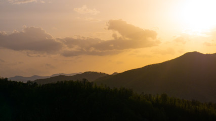 Beautiful landscape in the mountains at sunset. View of colorful sky with amazing clouds.
